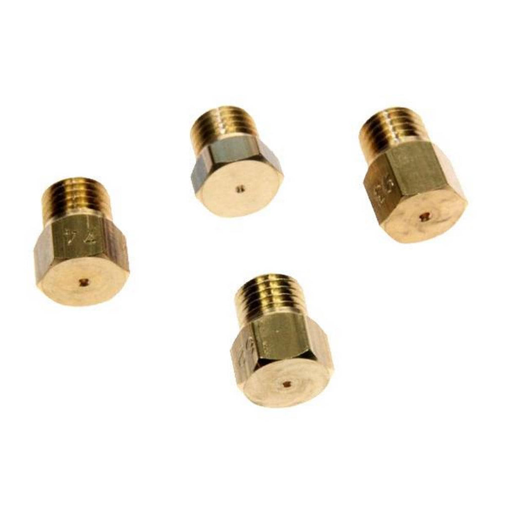 Four brass gas jet fittings on a white background